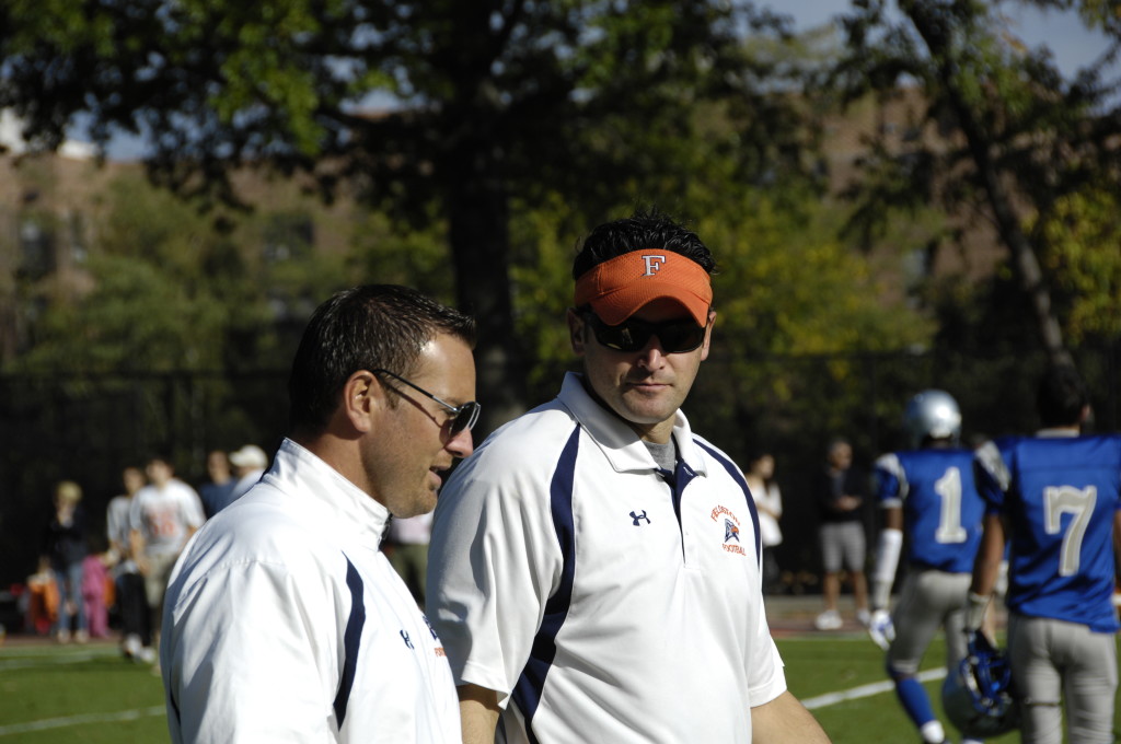 Gus Ornstein (right) and coach Scott Sousa (left) consult at this season’s homecoming game against Poly Prep