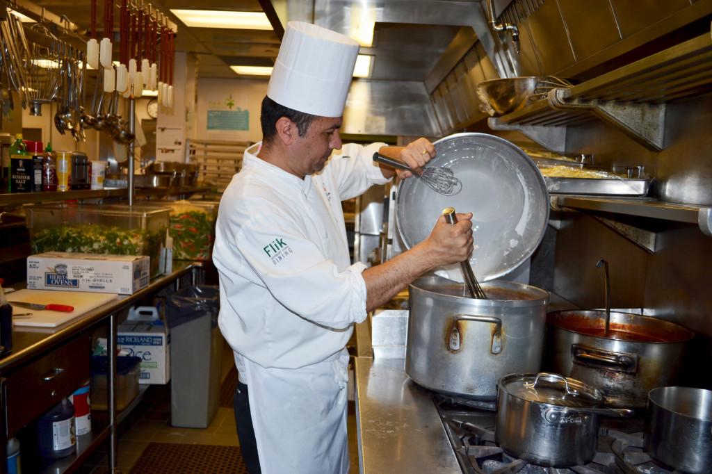 Flik Chef Danilo Acevedo cooking lunch in the upper school kitchen which will serve both the middle and upper school students Photo by David Fishman