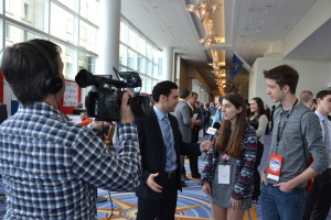 Photo by David Fishman: Hollis Lehv (V) and Nick Garber (VI) being interviewed by Drew Brody for One America News Network