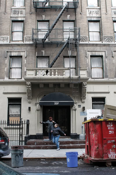 Two women walking out of building in Upper West Side