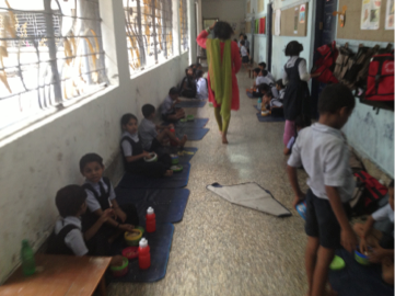 Free mid-day meals are served daily-the biggest draw for attendance.